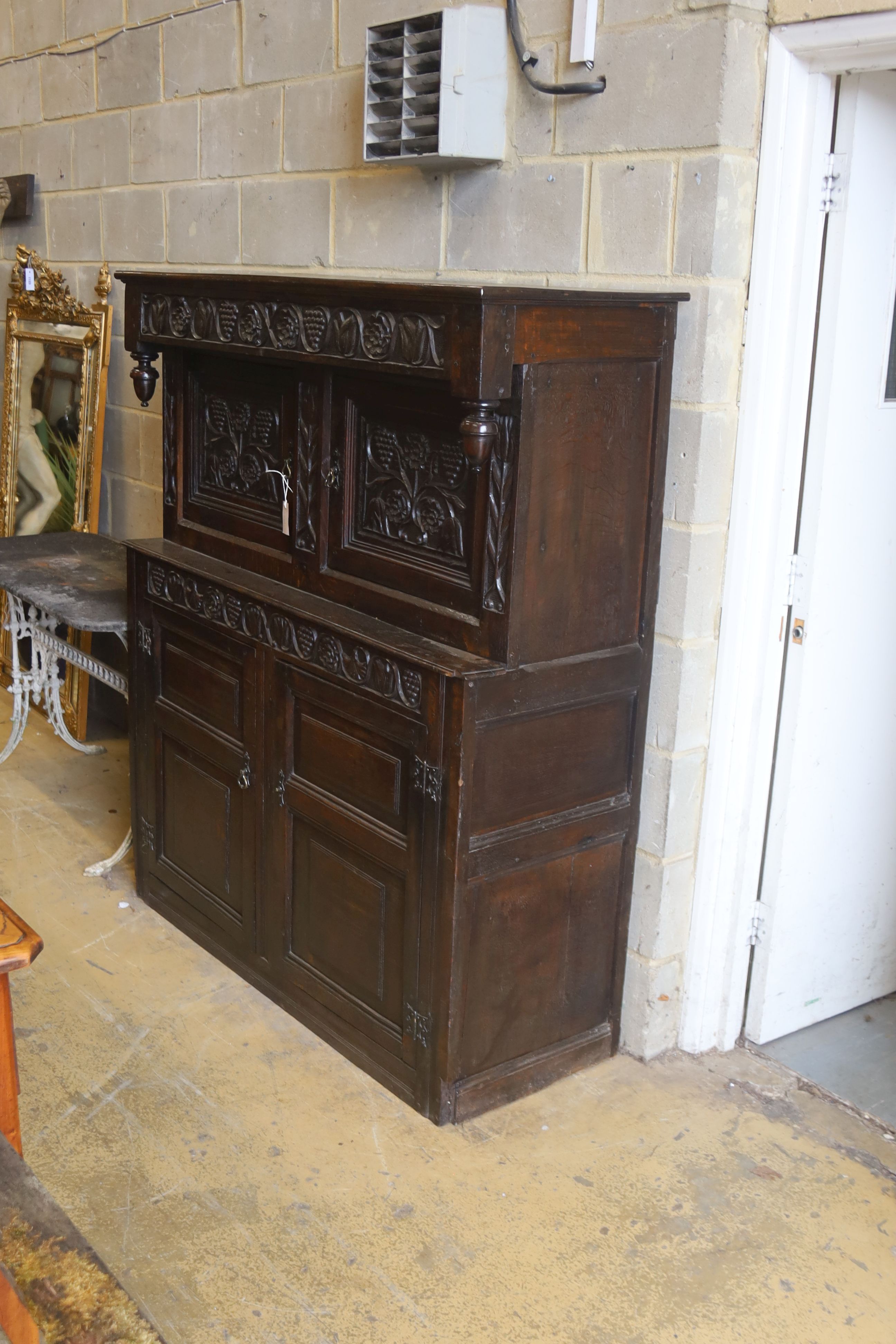 An 18th century carved oak court cupboard, length 134cm, depth 50cm, height 158cm